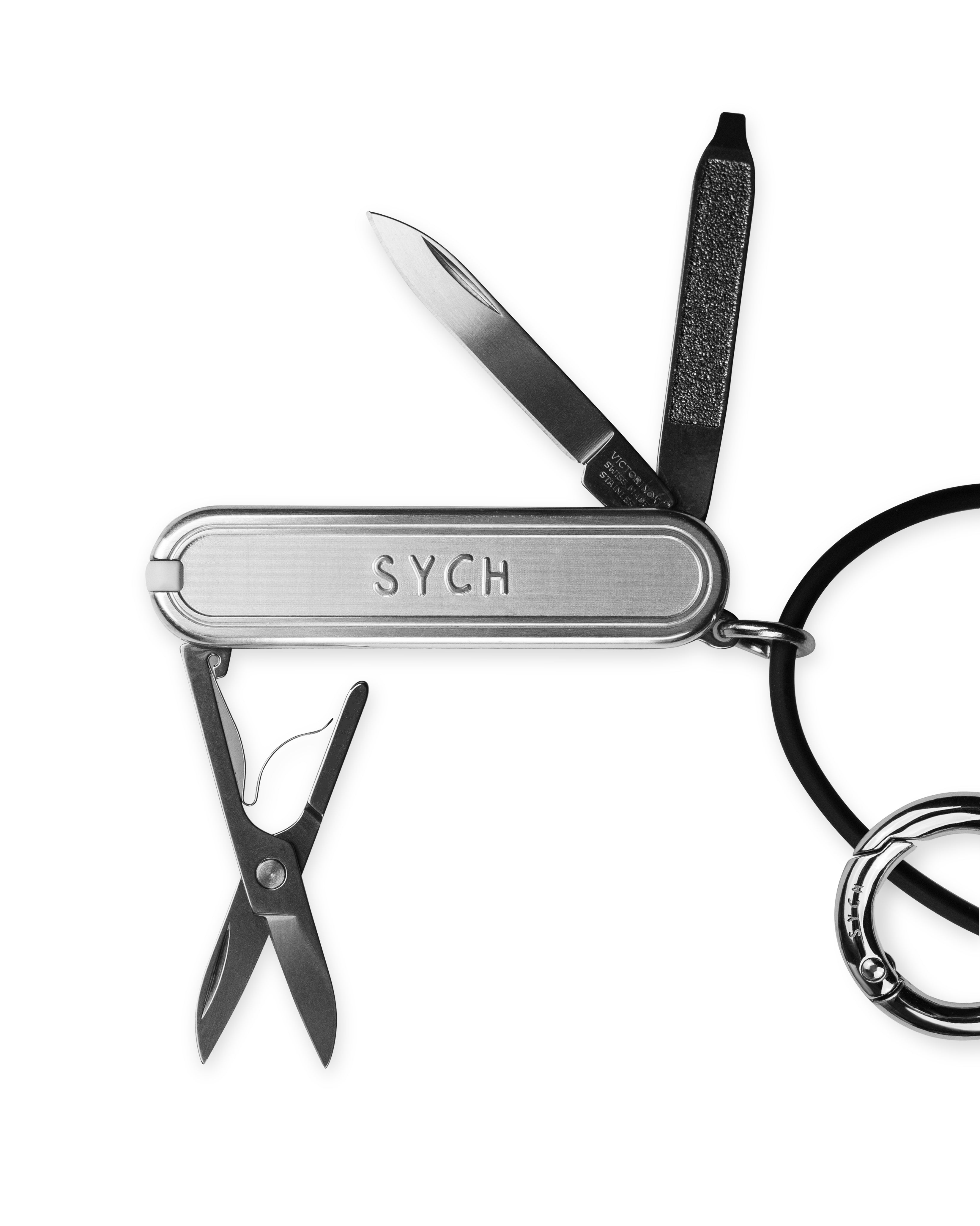 Multitool Sych with knife, scissors, and other tools on a white background